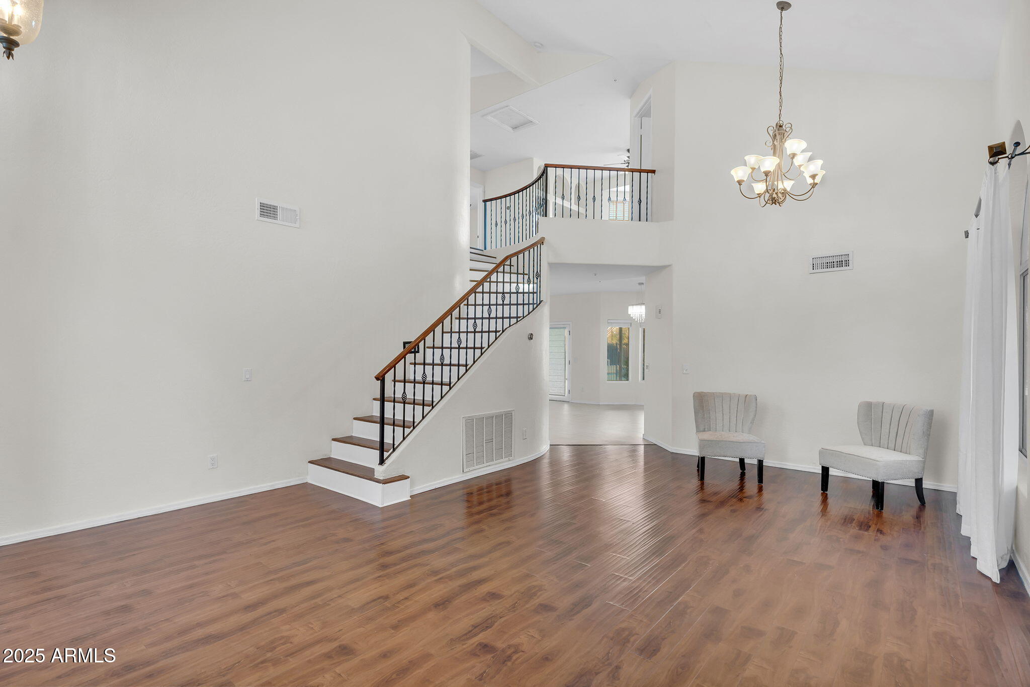 14566 North 100th Place Scottsdale, AZ 85260 - Photo 4 of 34 a view of a livingroom with wooden floor and a chandelier