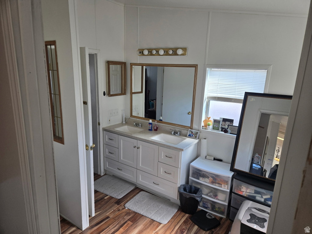 2180 North 1950th Street West Helper, UT 84526 - Photo 9 of 11 Bathroom with double vanity and dark wood finished floors