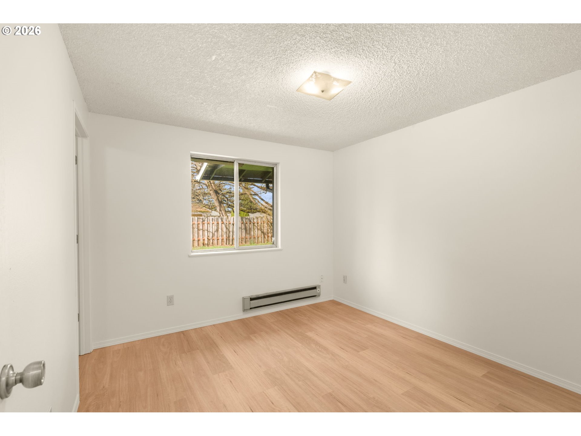 2635 Southeast 170th Avenue Portland, OR 97236 - Photo 16 of 22 an empty room with wooden floor and windows