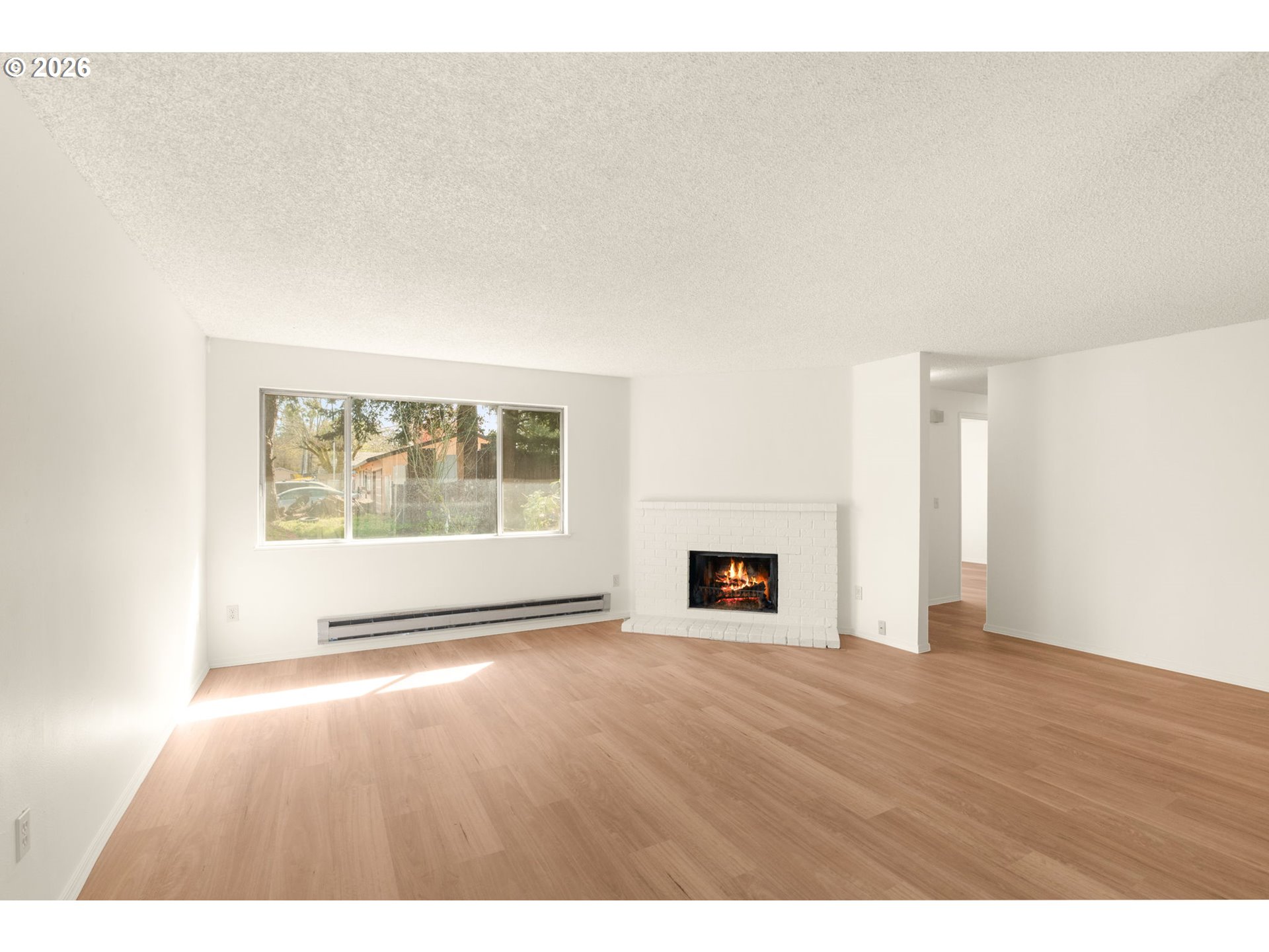 2635 Southeast 170th Avenue Portland, OR 97236 - Photo 4 of 22 a view of an empty room with wooden floor and a window