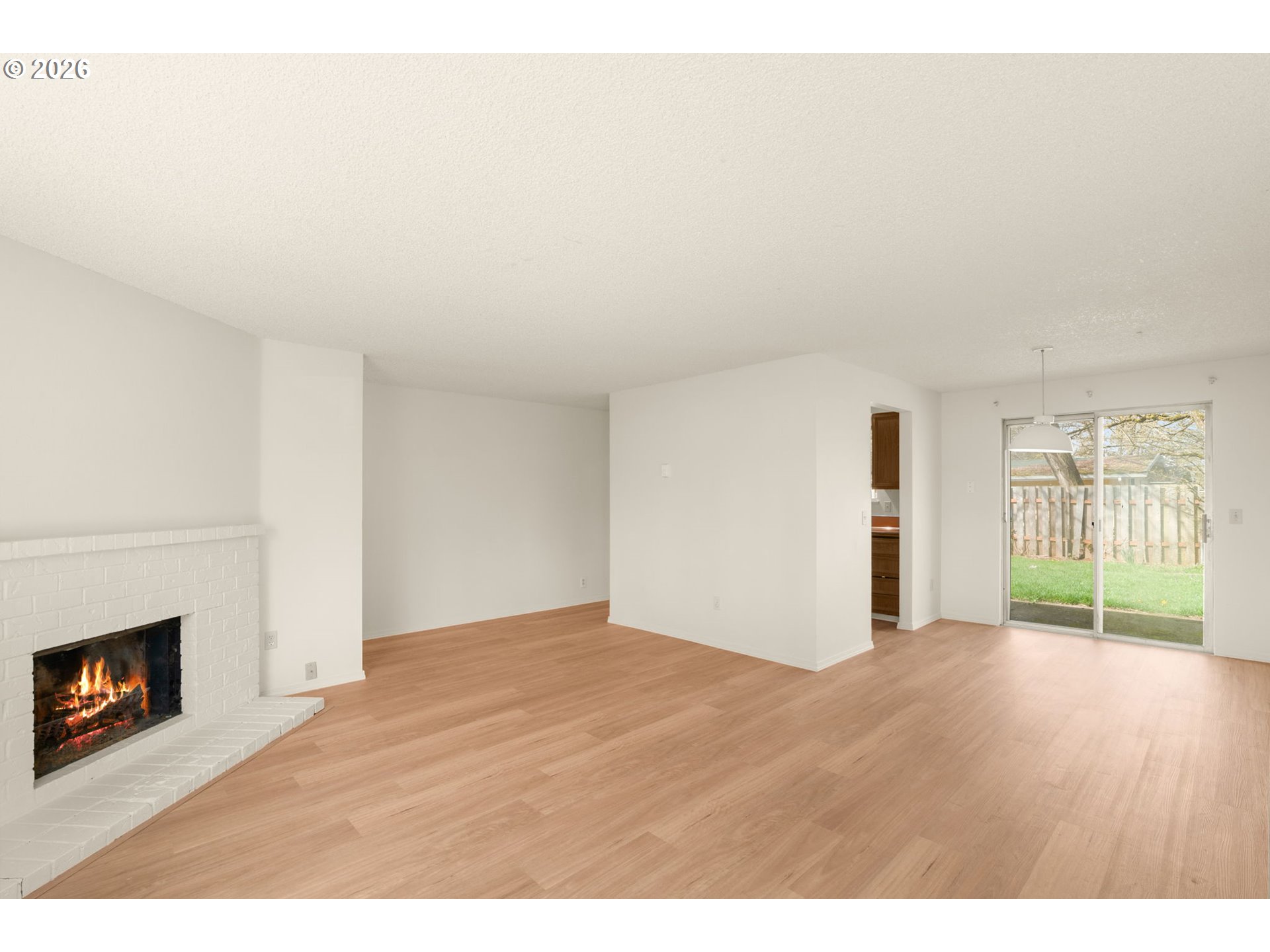 2635 Southeast 170th Avenue Portland, OR 97236 - Photo 7 of 22 a view of empty room with wooden floor and fireplace