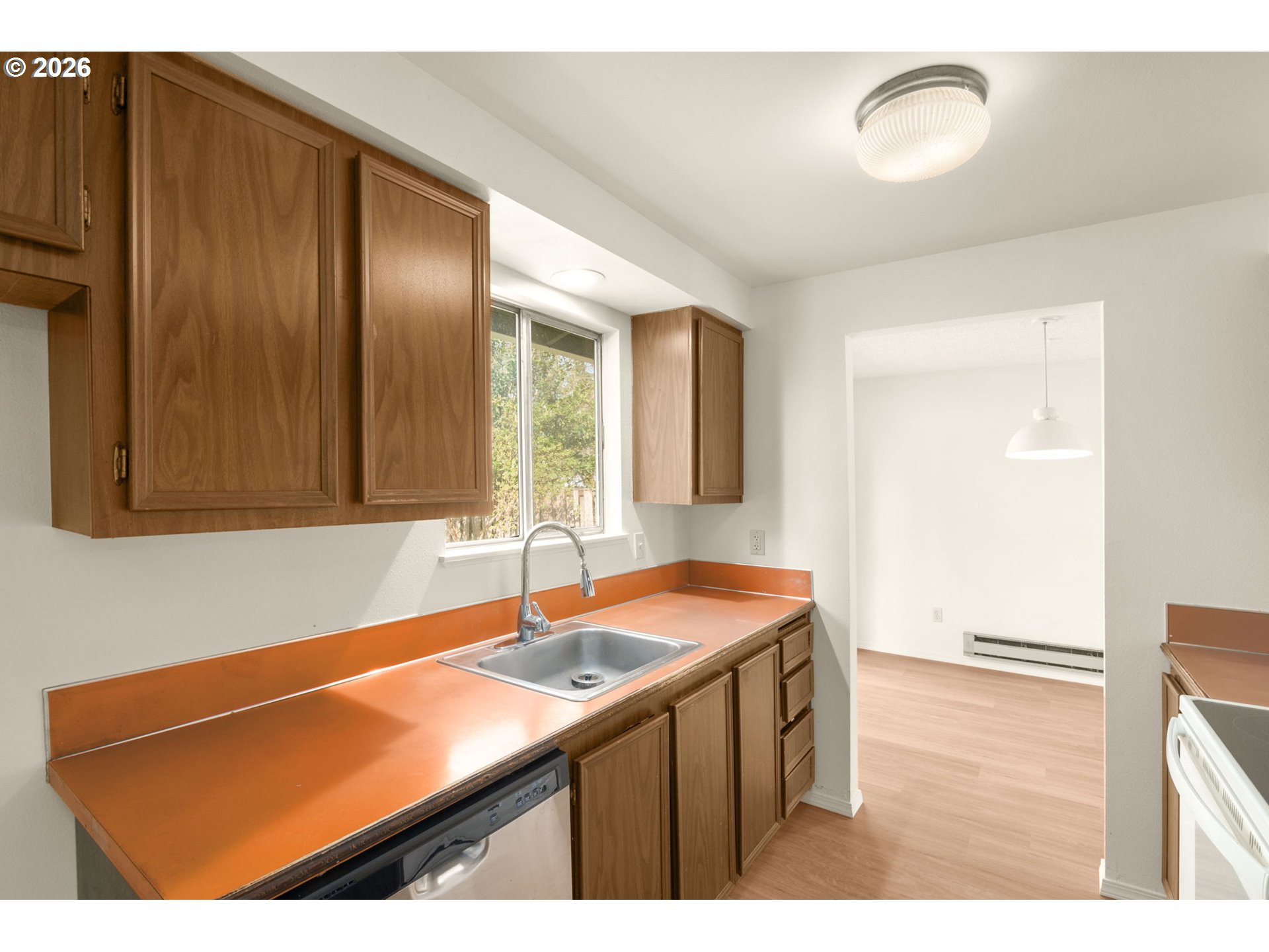 2635 Southeast 170th Avenue Portland, OR 97236 - Photo 9 of 22 a kitchen with a sink cabinets and a window