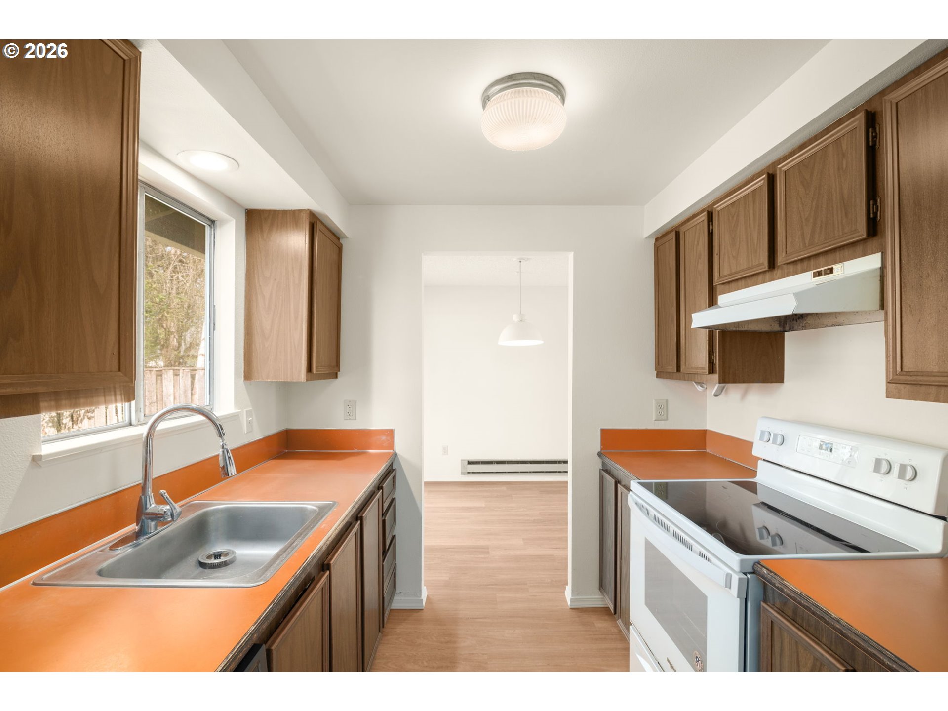 2635 Southeast 170th Avenue Portland, OR 97236 - Photo 10 of 22 a kitchen that has a sink and a stove