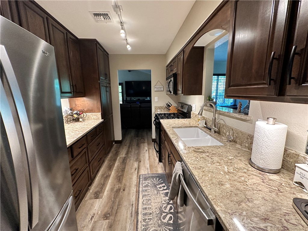 6615 Flag Mine Road Kingman, AZ 86401 - Photo 18 of 72 a kitchen with stainless steel appliances granite countertop a refrigerator a stove and a sink