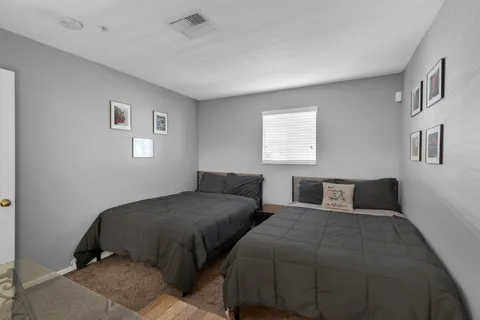 a bedroom with two beds and a window