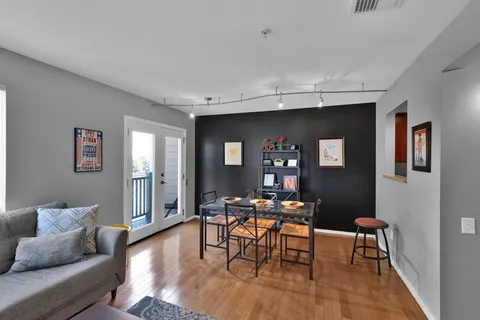 a living room with furniture and wooden floor