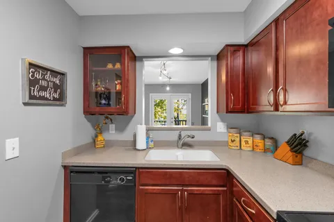 a kitchen with a sink cabinets and window