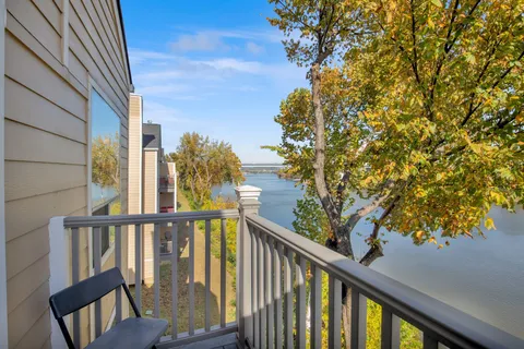 a view of a balcony with wooden fence and floor