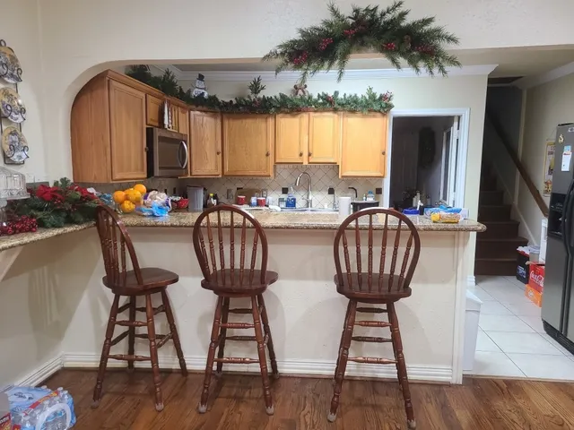 a view of a dining room with furniture and a potted plant