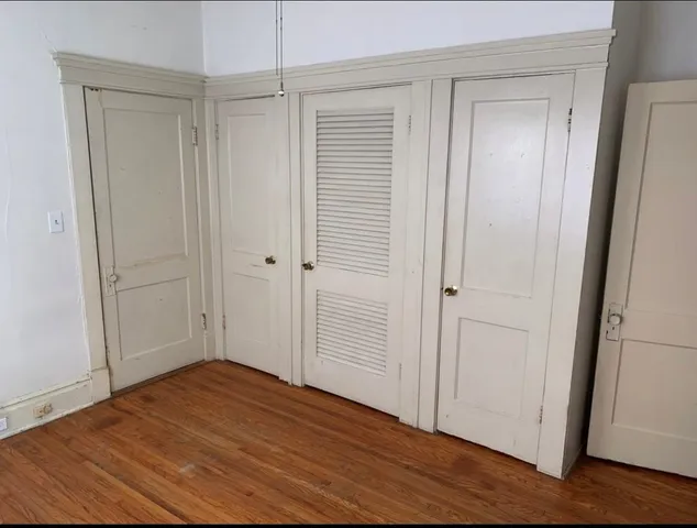 an empty room with wooden floor