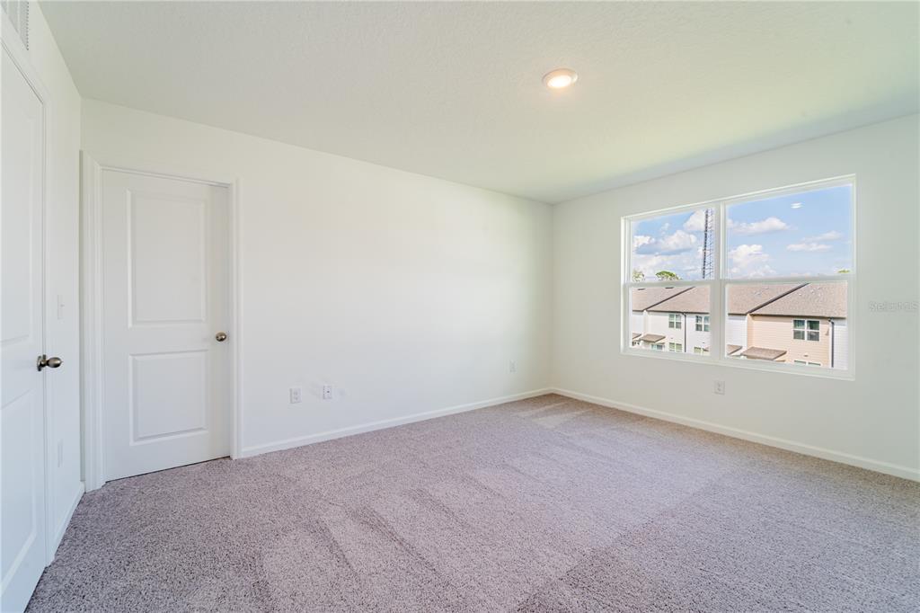 6174 Daerr Rdg Street Zephyrhills, FL 33542 - Photo 11 of 41 an empty room with windows and mirror