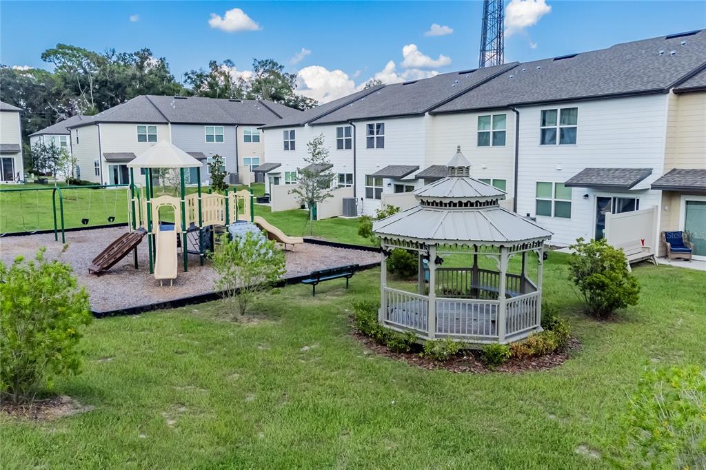 6174 Daerr Rdg Street Zephyrhills, FL 33542 - Photo 30 of 41 a view of a house with backyard and a garden