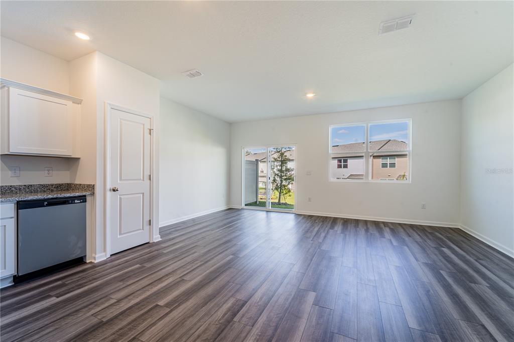 6174 Daerr Rdg Street Zephyrhills, FL 33542 - Photo 33 of 41 a view of an empty room with a window and wooden floor