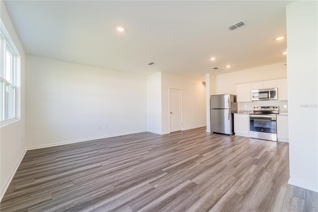 6174 Daerr Rdg Street Zephyrhills, FL 33542 - Photo 37 of 41 a view of kitchen and wooden floor