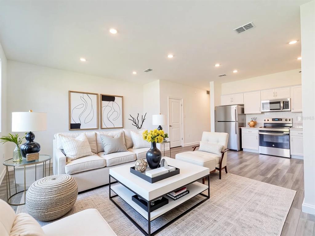6174 Daerr Rdg Street Zephyrhills, FL 33542 - Photo 5 of 41 a living room with furniture and kitchen view