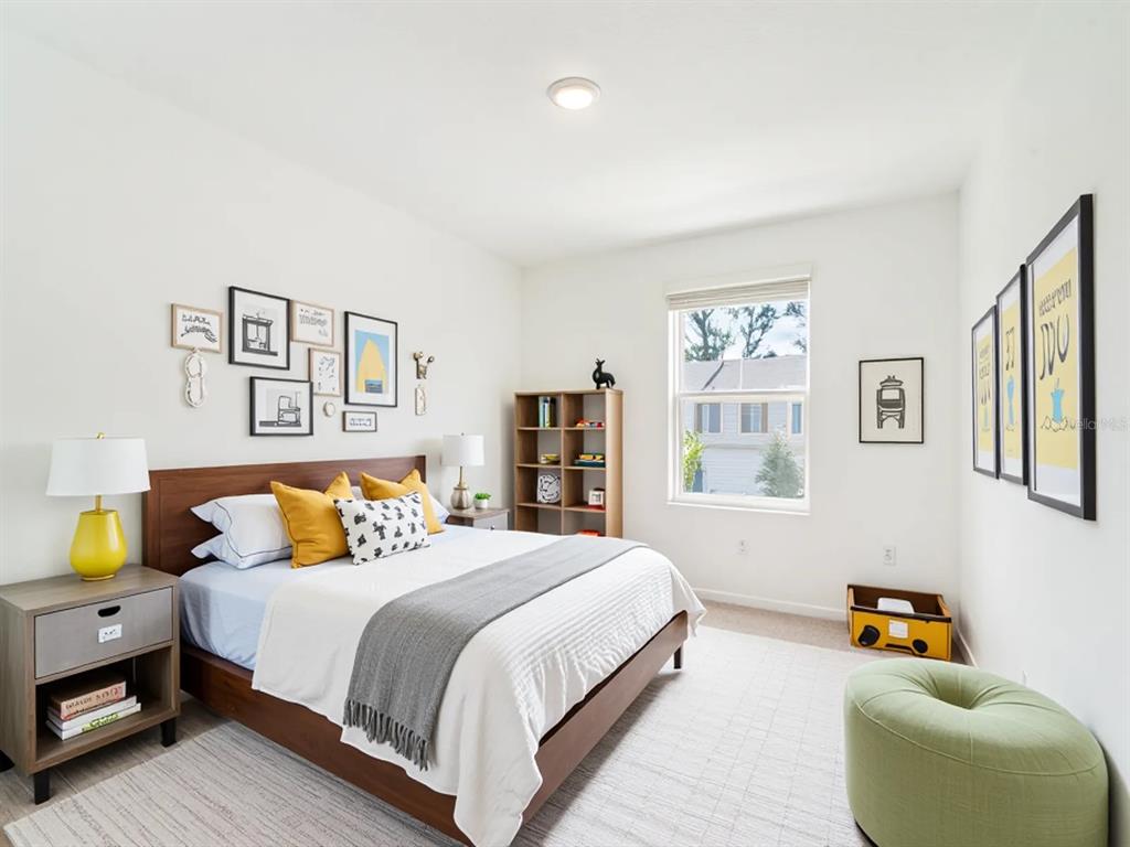 6174 Daerr Rdg Street Zephyrhills, FL 33542 - Photo 7 of 41 a bedroom with a bed and a couch