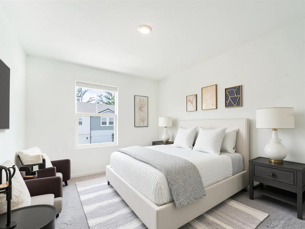 6174 Daerr Rdg Street Zephyrhills, FL 33542 - Photo 8 of 41 a bedroom with a bed and a couch