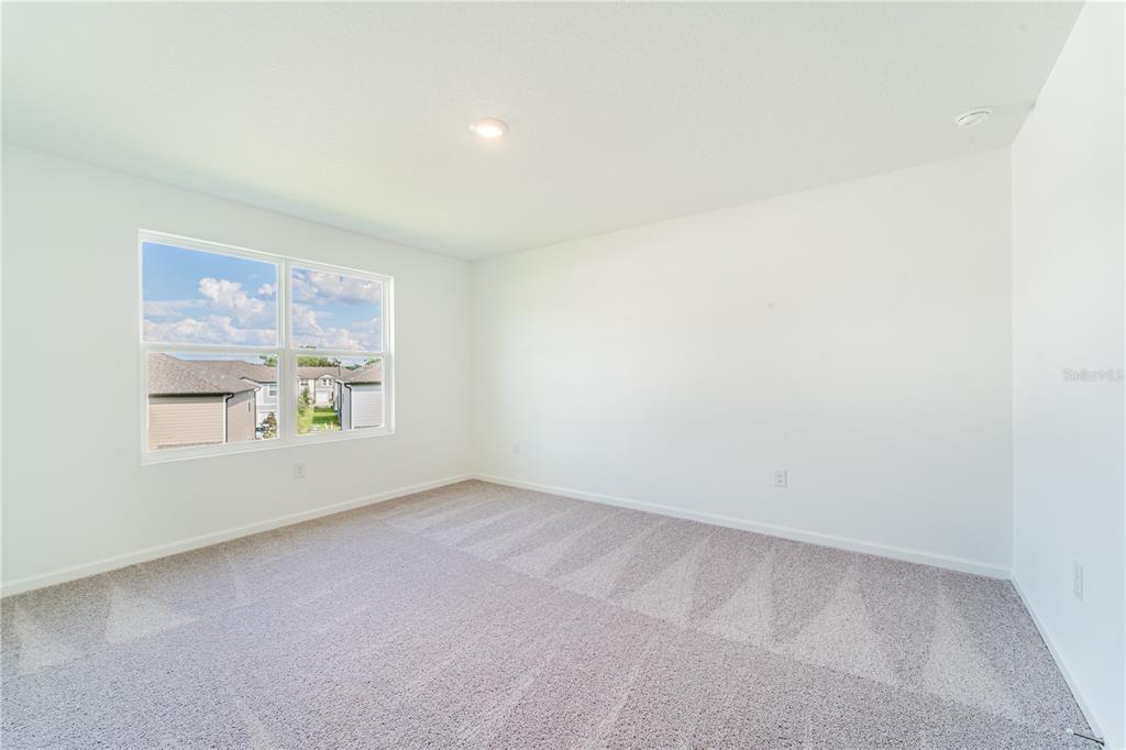 6174 Daerr Rdg Street Zephyrhills, FL 33542 - Photo 10 of 41 an empty room with windows