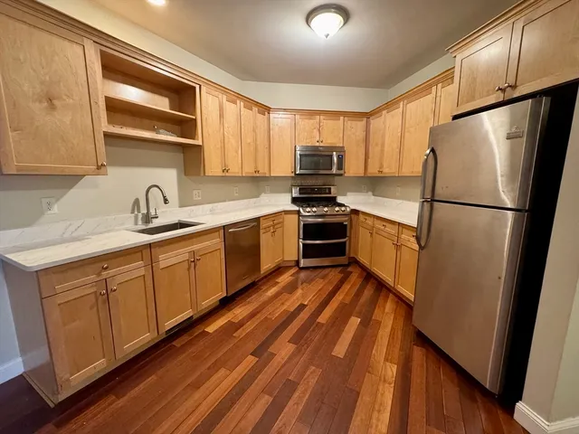 a kitchen with stainless steel appliances a refrigerator sink and microwave