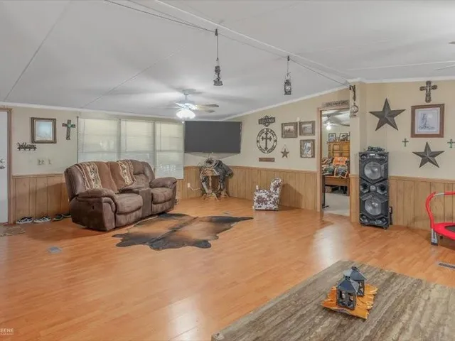 a kitchen with kitchen island granite countertop a sink dishwasher stove and cabinets