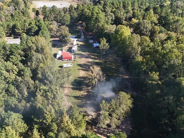a view of a backyard with swimming pool and sitting area