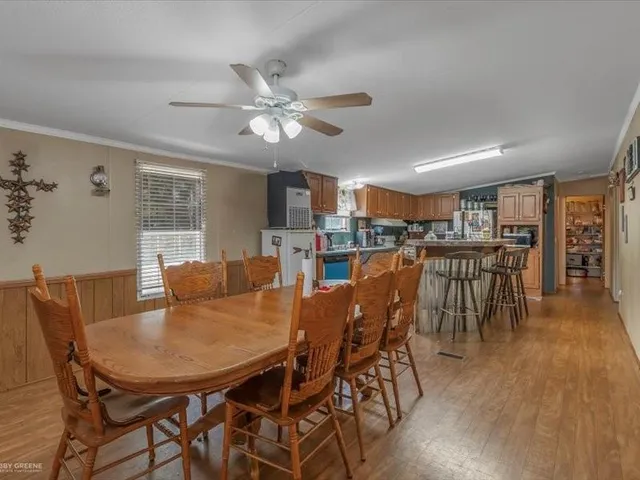 a view of a dining room with furniture and wooden floor
