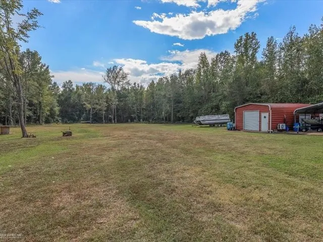 a backyard of a house with lots of green space