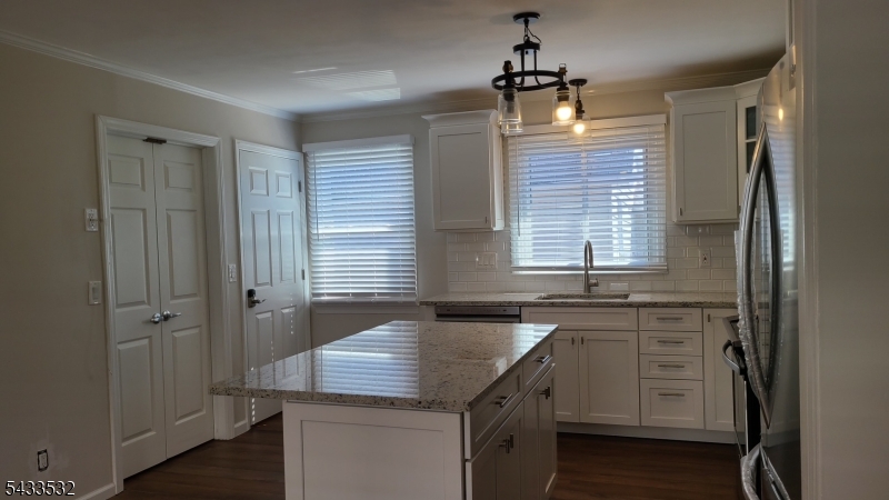16 Ocean Street Millburn, NJ 07041 - Photo 3 of 26 a kitchen with a sink stove and cabinets