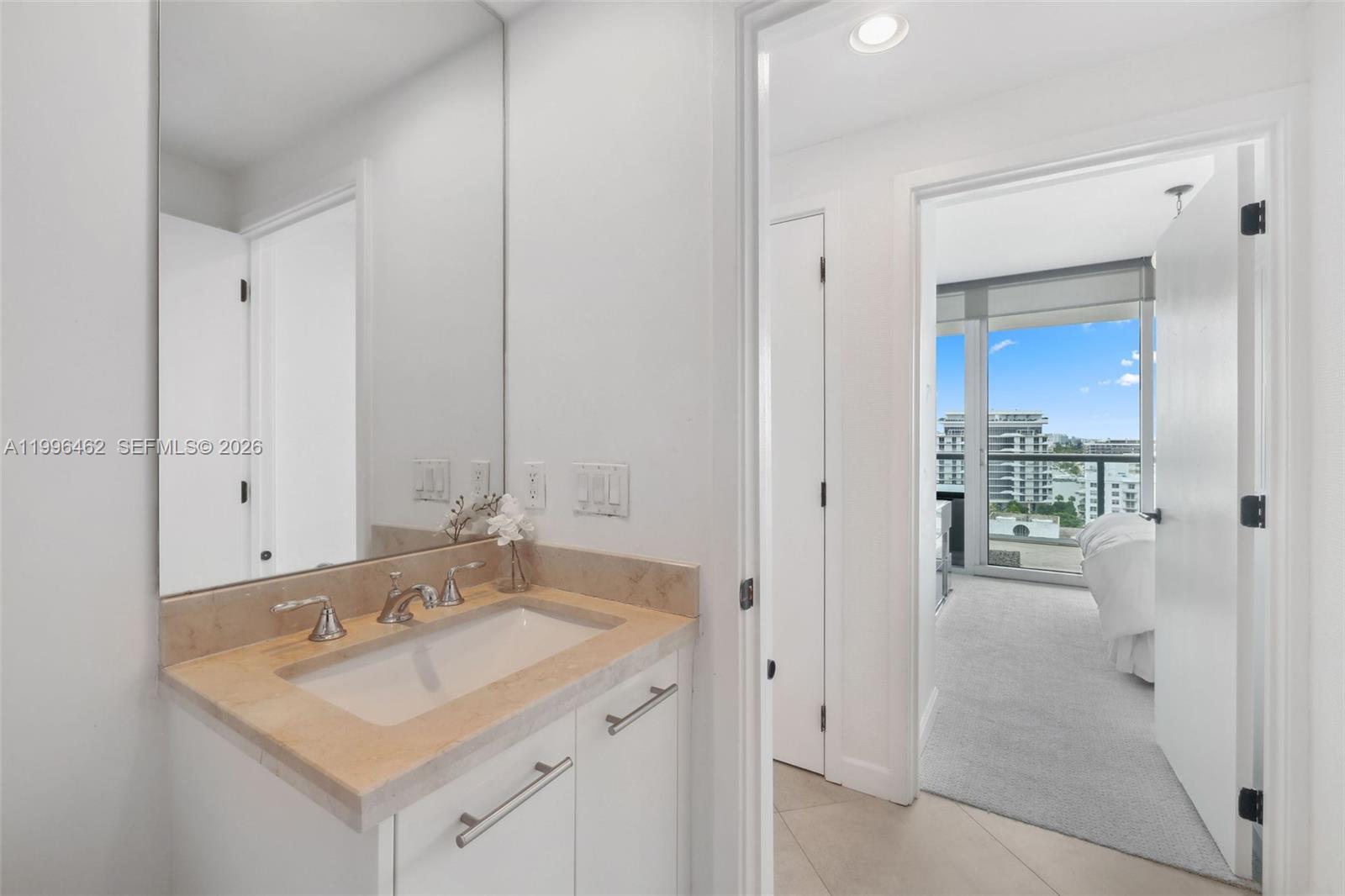 6799 Collins Avenue, Unit 1106 Miami Beach, FL 33141 - Photo 17 of 35 a bathroom with a sink and a mirror