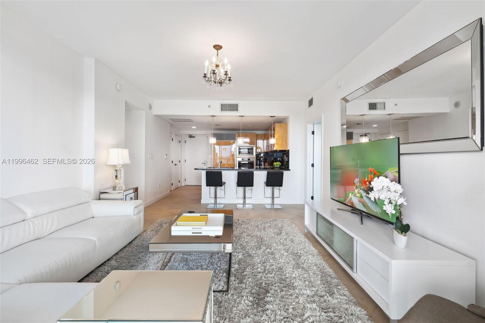 6799 Collins Avenue, Unit 1106 Miami Beach, FL 33141 - Photo 9 of 35 a living room with furniture and a fireplace