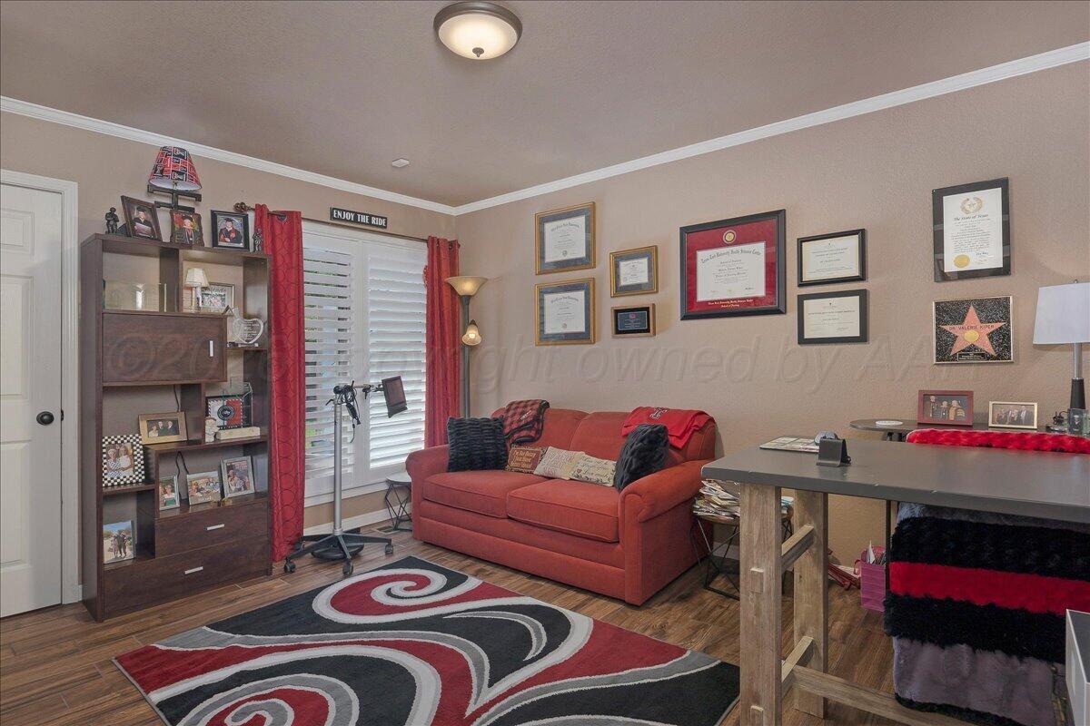 5 Locke Place Amarillo, TX 79124 - Photo 23 of 53 a living room with furniture and a bookshelf