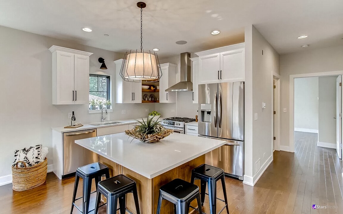 405 Duane Street Glen Ellyn, IL 60137 - Photo 2 of 12 a kitchen with stainless steel appliances a dining table chairs and wooden floor