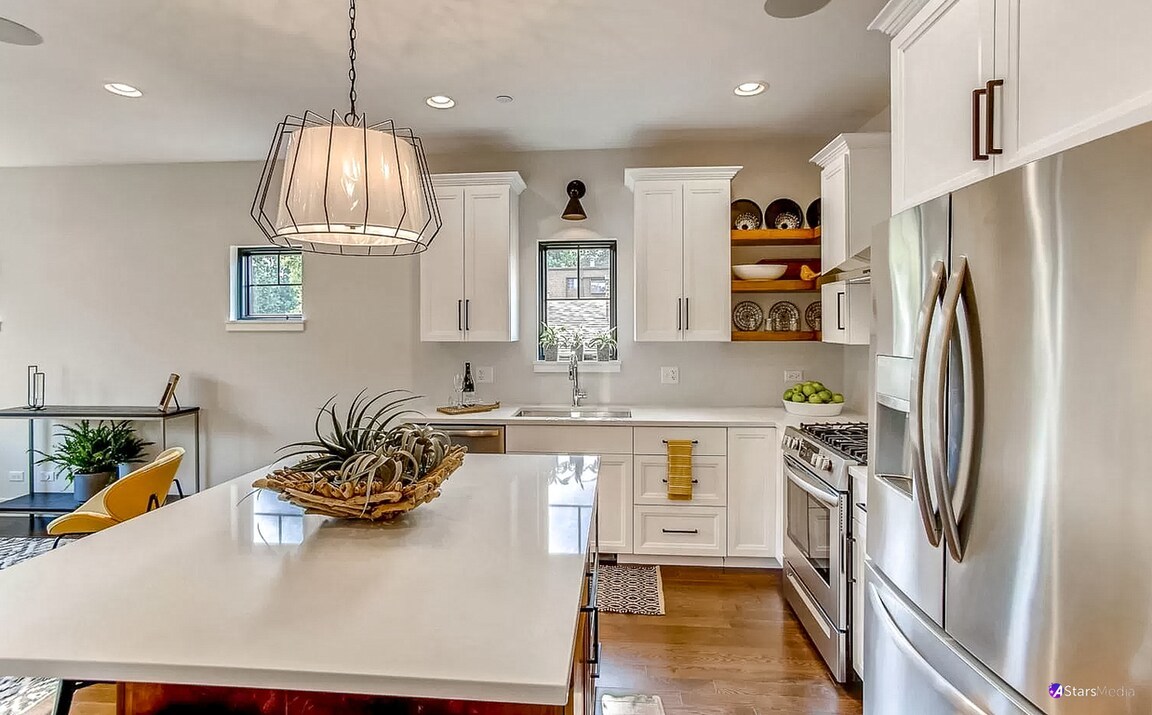 405 Duane Street Glen Ellyn, IL 60137 - Photo 3 of 12 a kitchen with stainless steel appliances a sink a stove a refrigerator cabinets and living room view