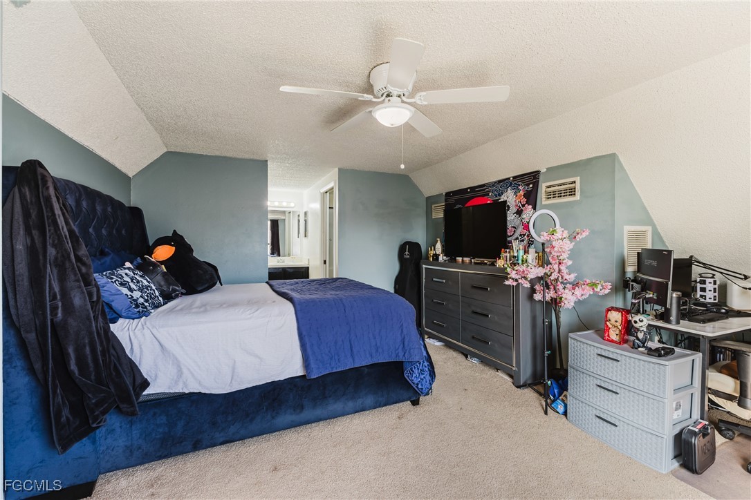 7393 Albany Road Fort Myers, FL 33967 - Photo 13 of 37 a bedroom with a bed and a tv