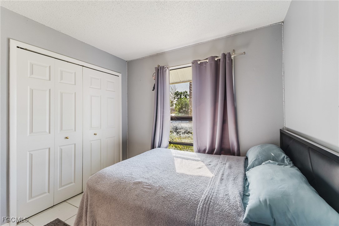 7393 Albany Road Fort Myers, FL 33967 - Photo 17 of 37 a bedroom with a bed and a window