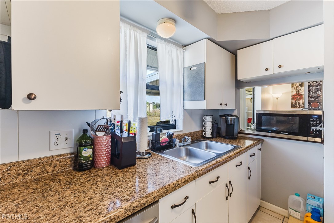 7393 Albany Road Fort Myers, FL 33967 - Photo 19 of 37 a kitchen with sink and cabinets