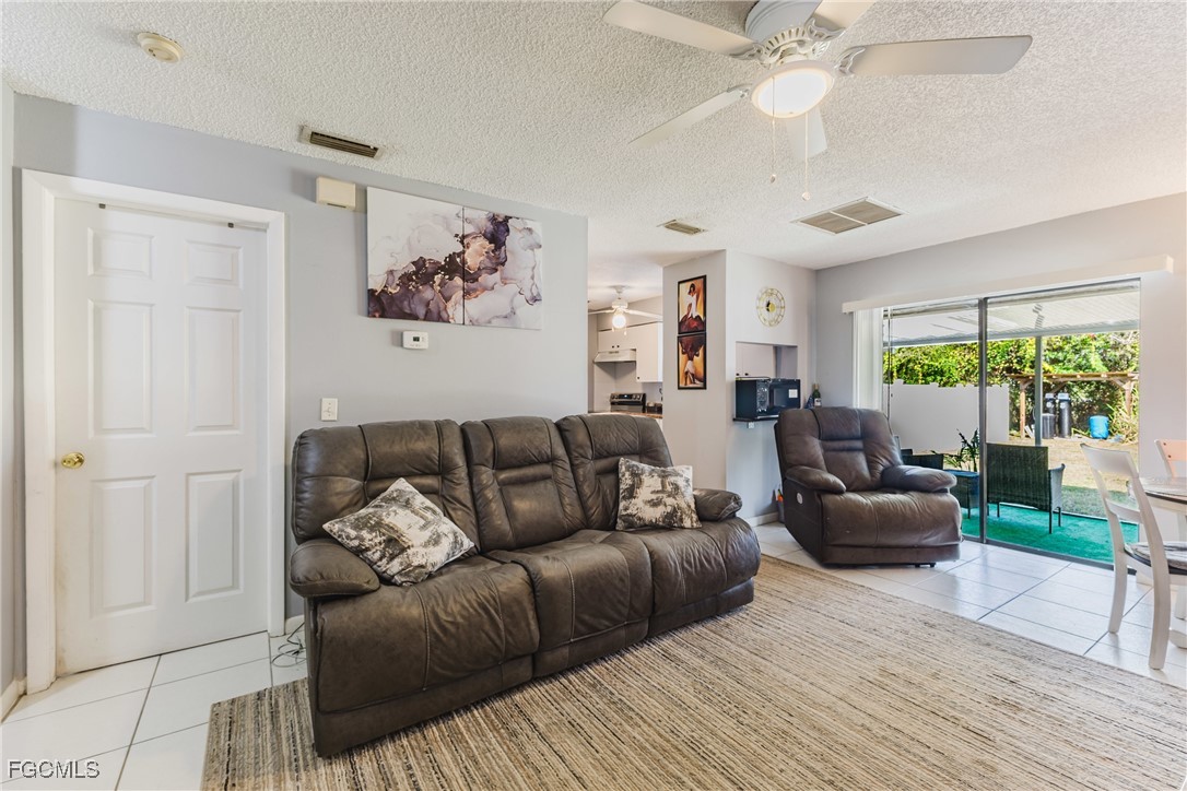 7393 Albany Road Fort Myers, FL 33967 - Photo 20 of 37 a living room with furniture and a large window