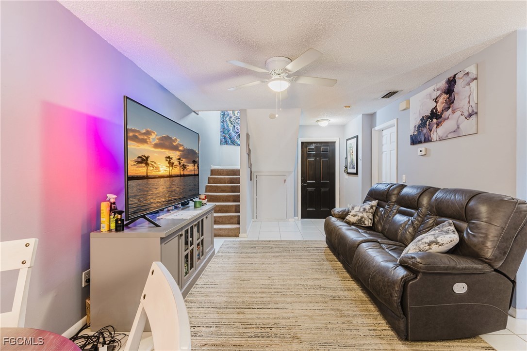 7393 Albany Road Fort Myers, FL 33967 - Photo 24 of 37 a living room with furniture and a flat screen tv