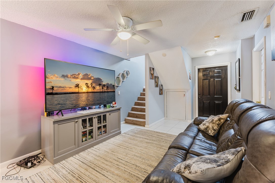 7393 Albany Road Fort Myers, FL 33967 - Photo 25 of 37 a living room with furniture and a flat screen tv
