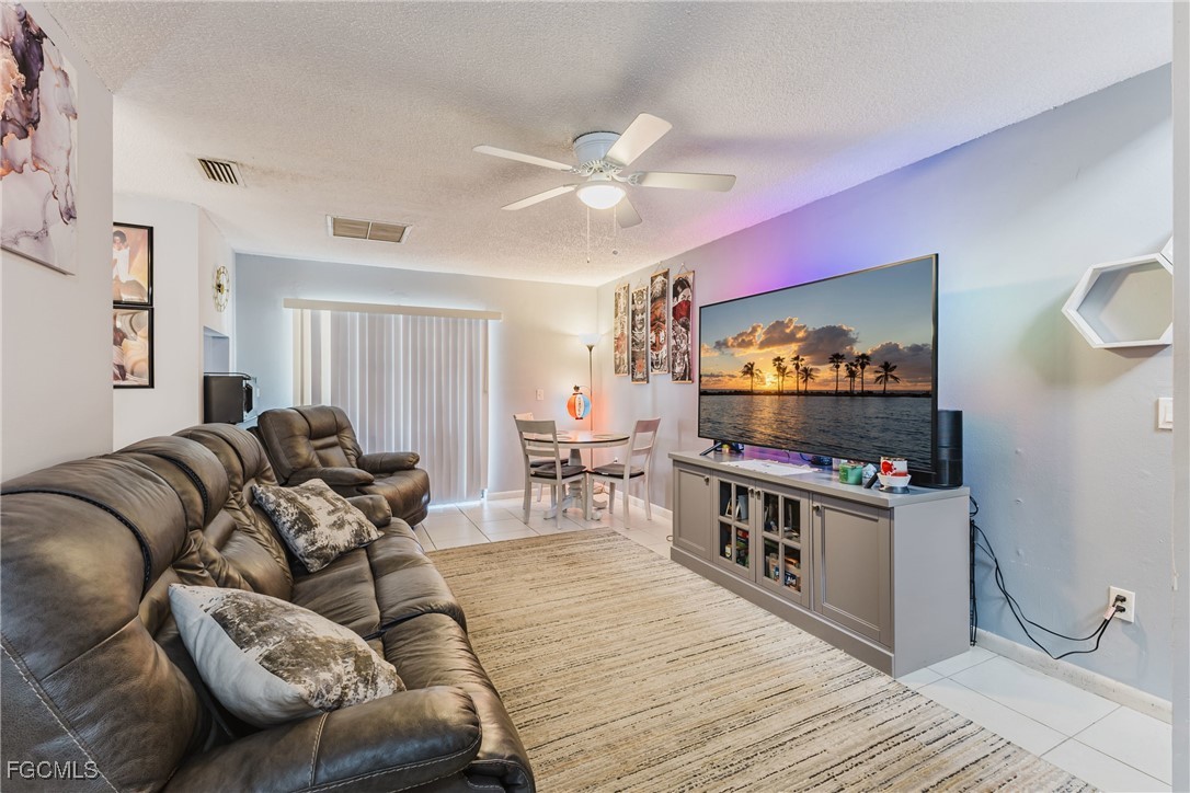 7393 Albany Road Fort Myers, FL 33967 - Photo 26 of 37 a living room with furniture and a flat screen tv