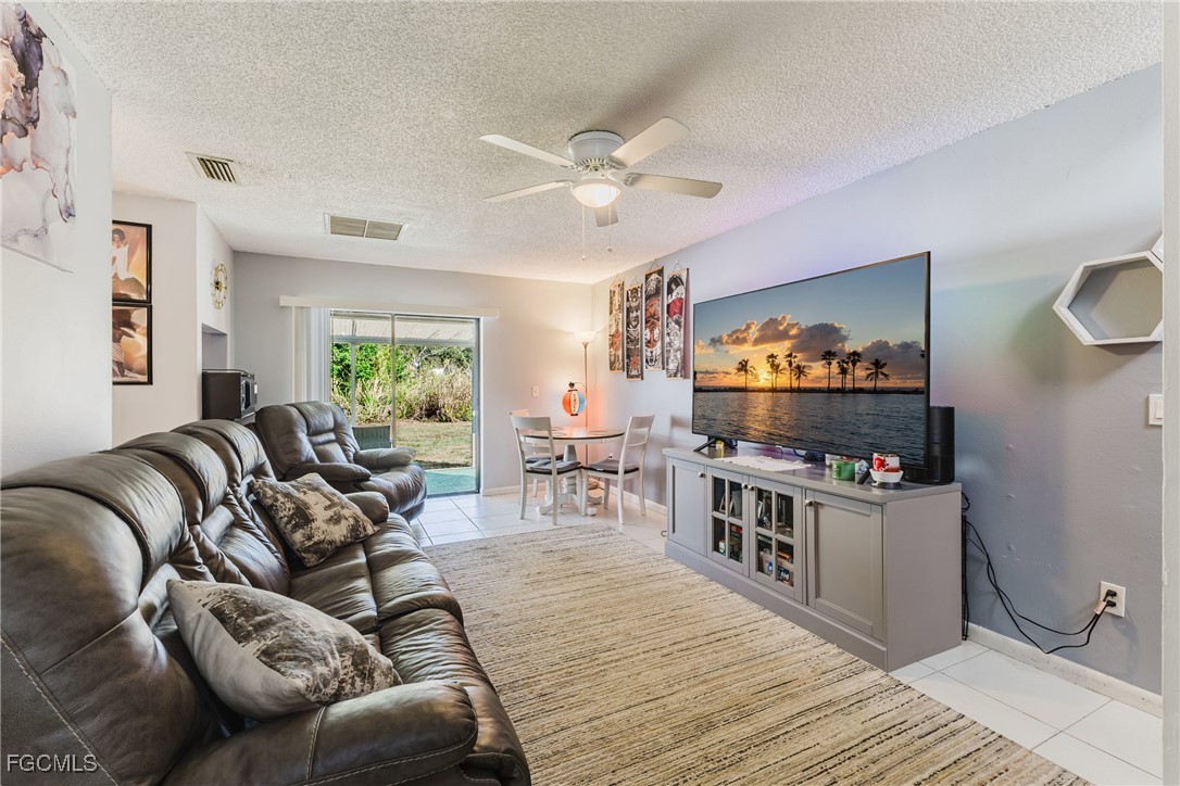 7393 Albany Road Fort Myers, FL 33967 - Photo 27 of 37 a living room with furniture and a wooden floor