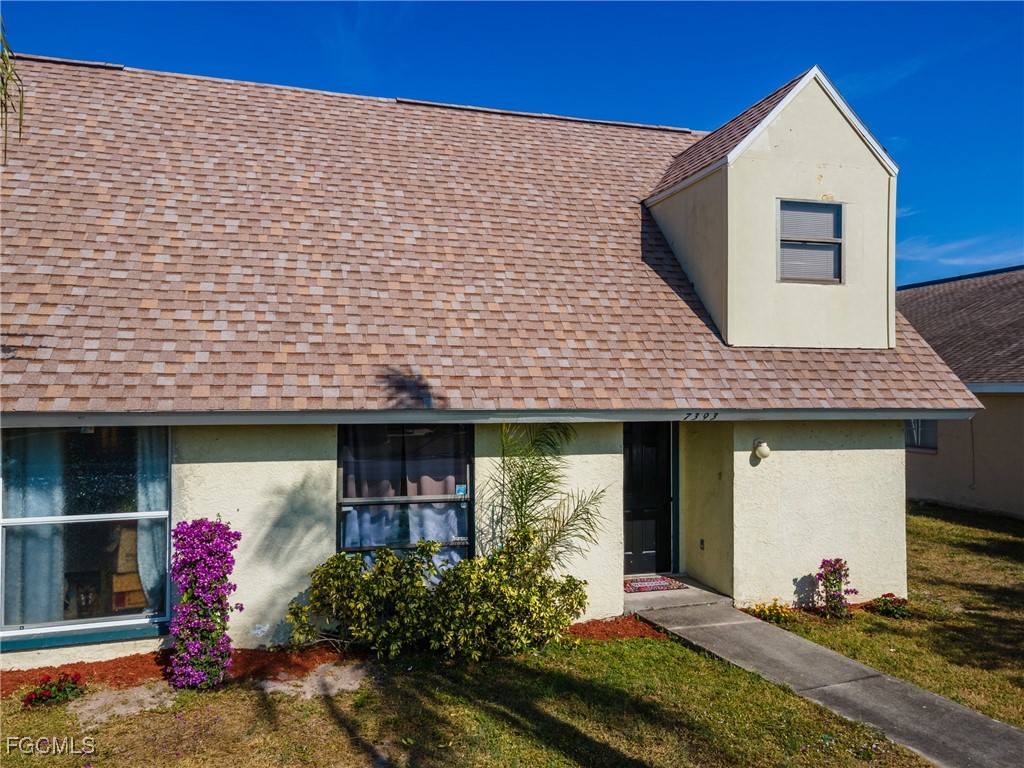 7393 Albany Road Fort Myers, FL 33967 - Photo 28 of 37 a front view of a house with garden