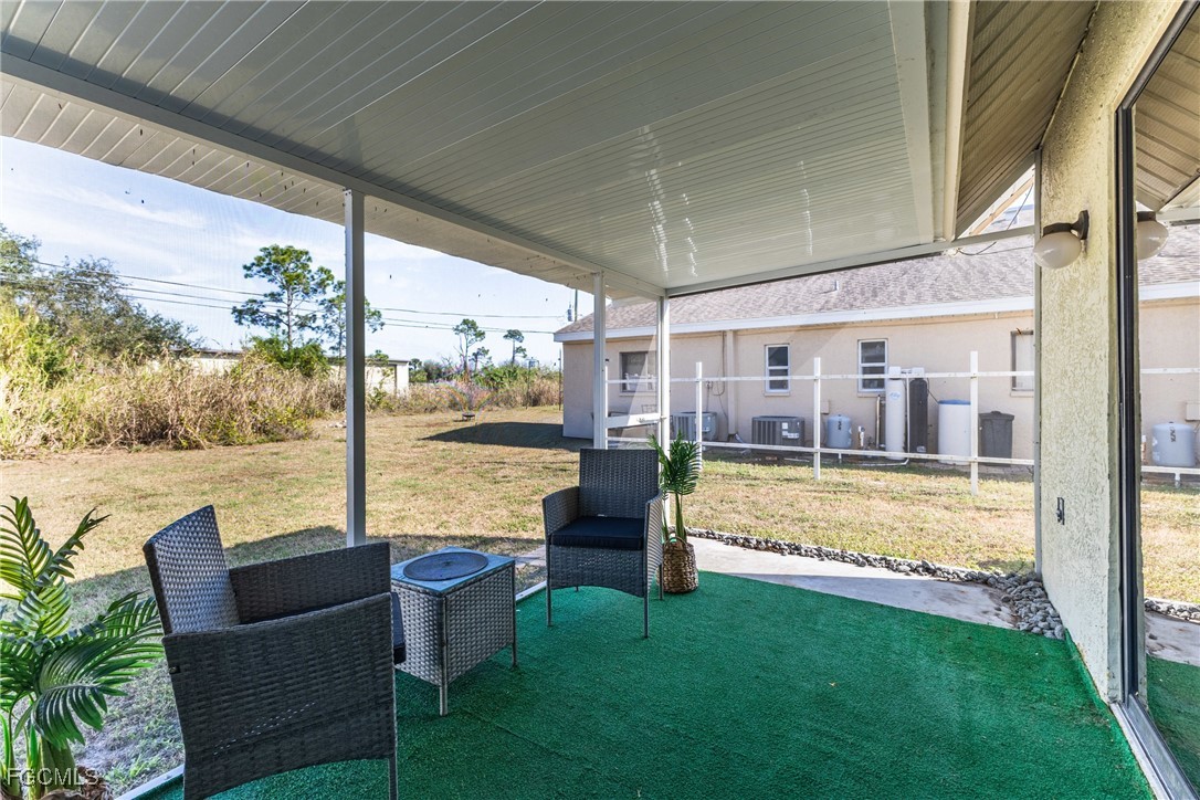 7393 Albany Road Fort Myers, FL 33967 - Photo 7 of 37 a view of a swimming pool with a couches in a patio