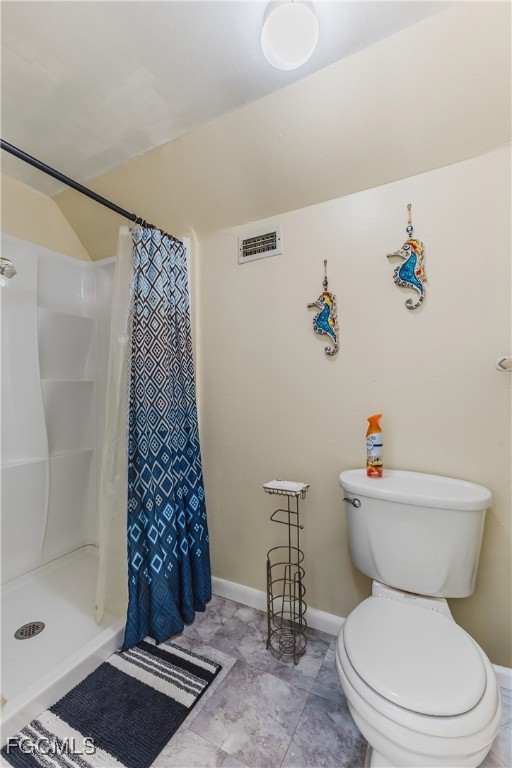 7393 Albany Road Fort Myers, FL 33967 - Photo 9 of 37 a white toilet sitting next to a bathroom sink