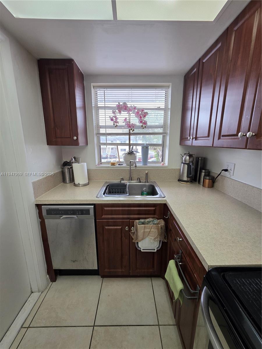7424 Southwest 82nd Street, Unit D215 Miami, FL 33143 - Photo 18 of 33 a kitchen with a sink and a stove top oven