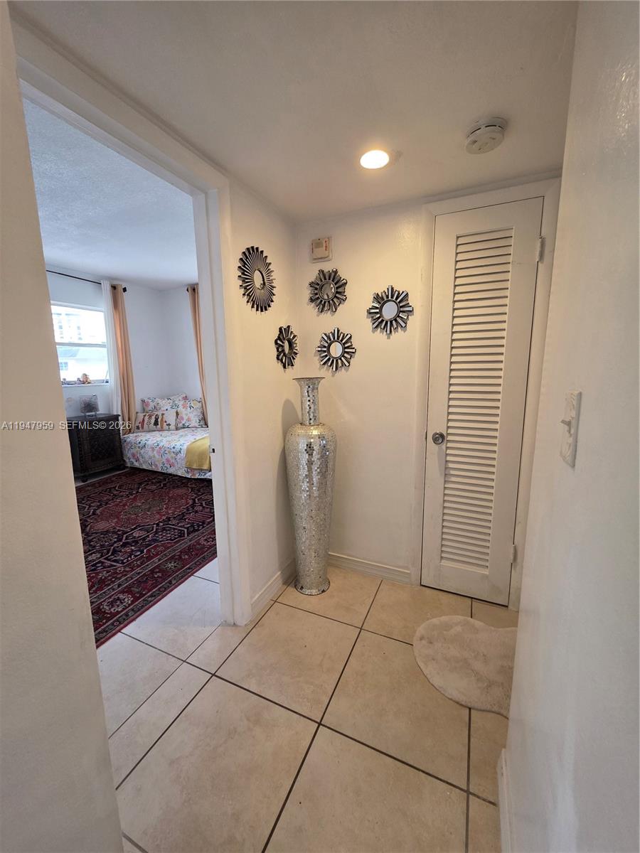 7424 Southwest 82nd Street, Unit D215 Miami, FL 33143 - Photo 19 of 33 a view of a hallway to rooms and stairs