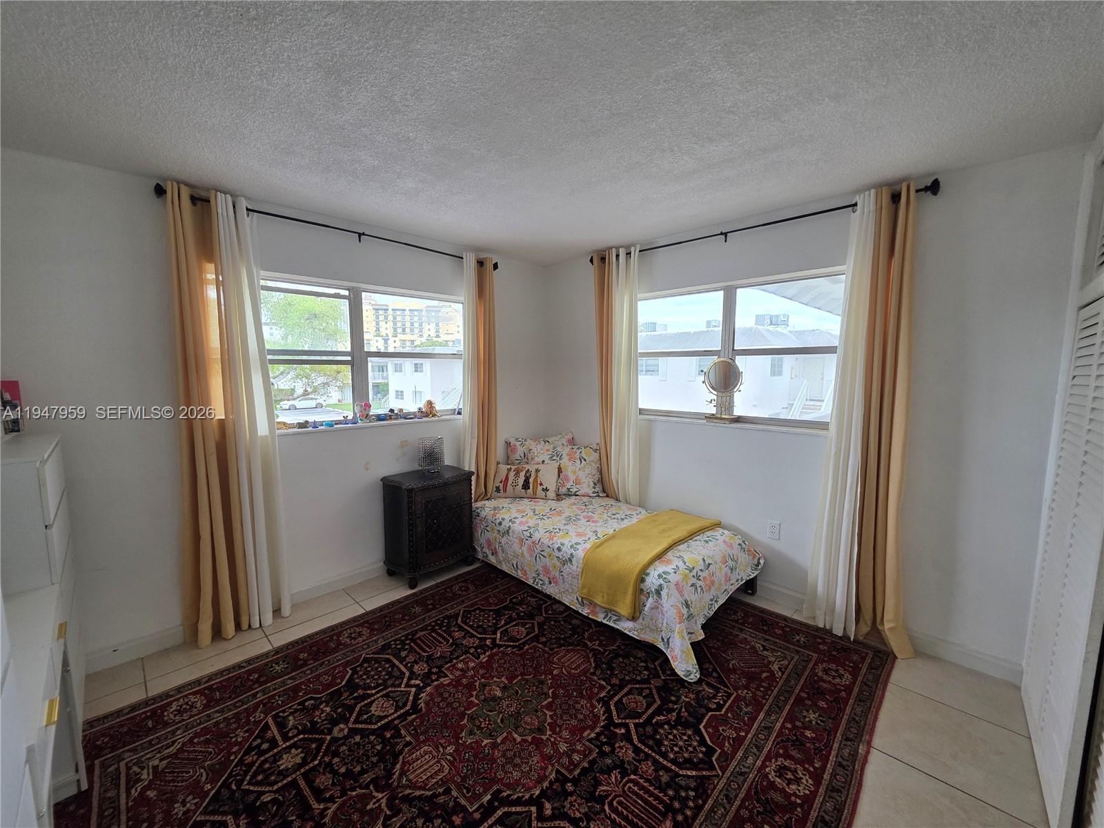 7424 Southwest 82nd Street, Unit D215 Miami, FL 33143 - Photo 20 of 33 a bedroom with a bed and a window