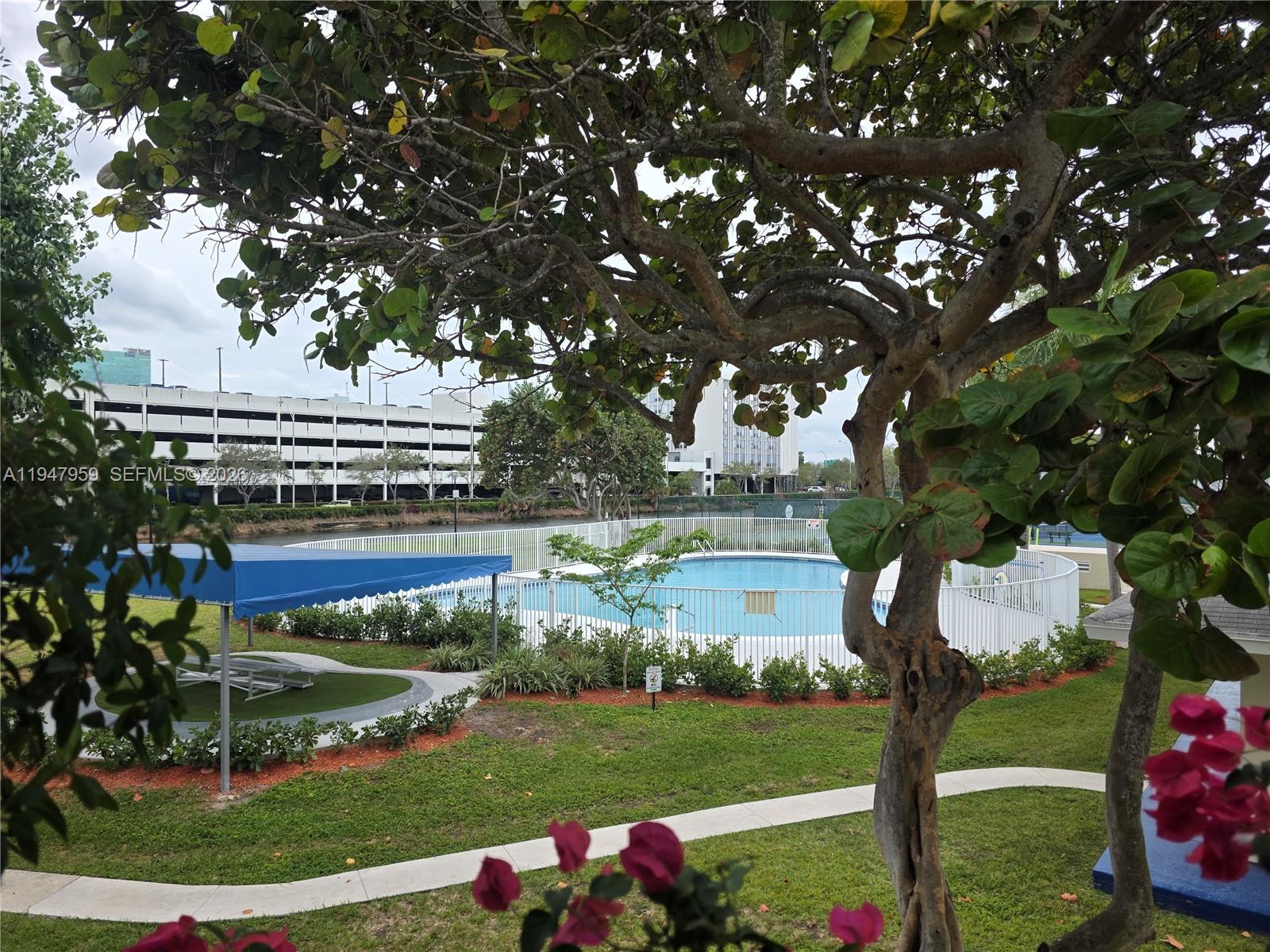 7424 Southwest 82nd Street, Unit D215 Miami, FL 33143 - Photo 2 of 33 a front view of a house with garden