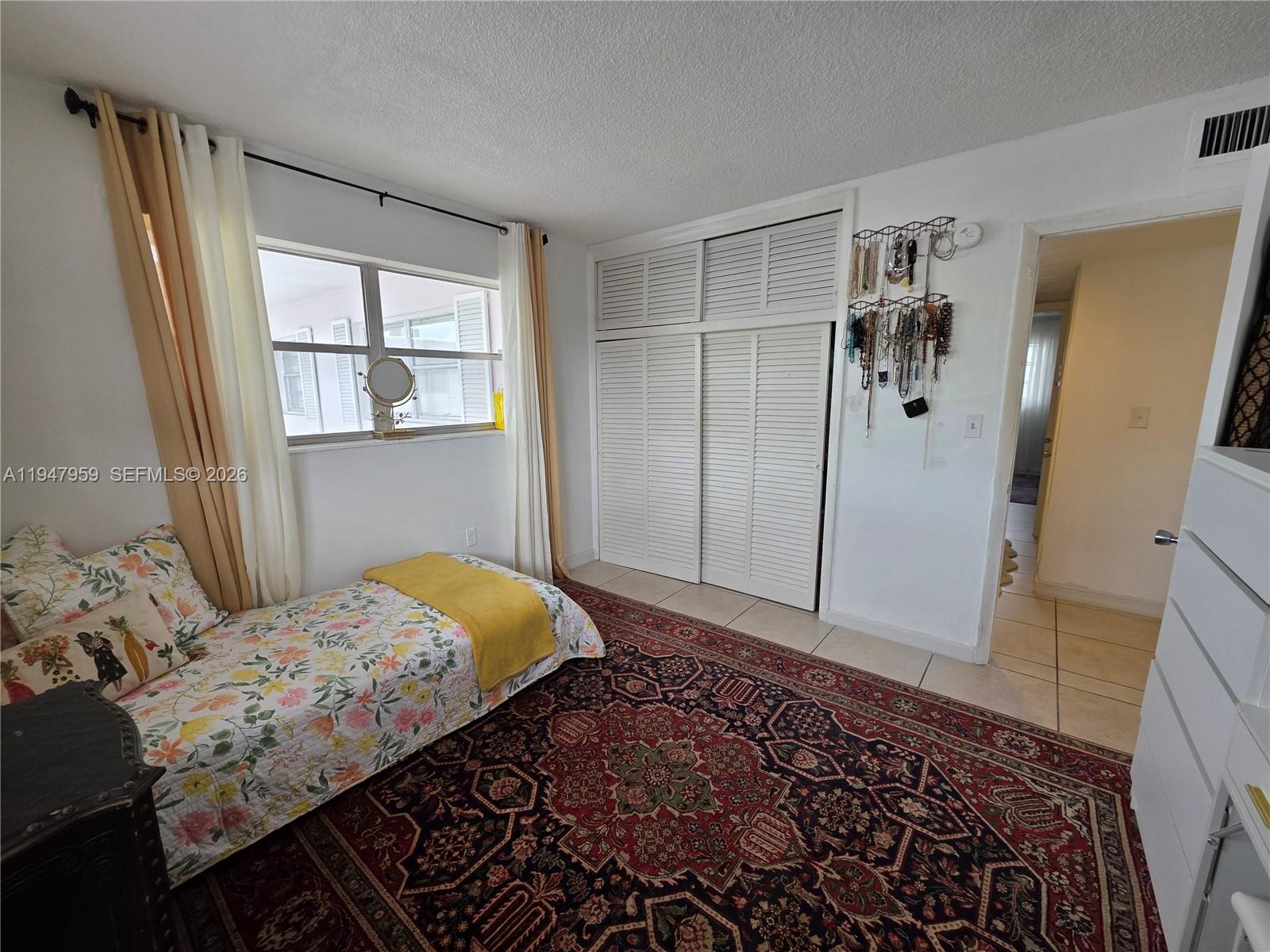 7424 Southwest 82nd Street, Unit D215 Miami, FL 33143 - Photo 21 of 33 a bedroom with a bed and a window