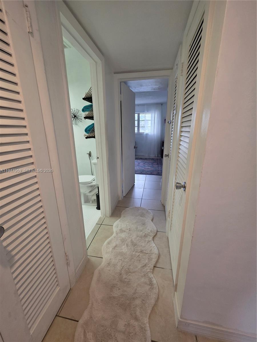 7424 Southwest 82nd Street, Unit D215 Miami, FL 33143 - Photo 25 of 33 a view of a hallway with wooden floor and a livingroom